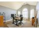 Spacious home office with vaulted ceilings, natural light, and a modern adjustable desk setup at 313 Masters Club Blvd, Hampton, GA 30228