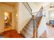 Beautiful staircase with wrought iron railings and hardwood flooring at 313 Masters Club Blvd, Hampton, GA 30228
