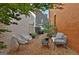 Cozy backyard featuring lounge seating, pea gravel and brick walls on a sunny day at 145 Kelmscott Ln, Fayetteville, GA 30214