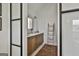 Bright and airy bathroom featuring double sinks, a wooden vanity, and modern decor at 145 Kelmscott Ln, Fayetteville, GA 30214