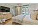 Cozy bedroom with a dresser, modern lighting, and patio access for outdoor enjoyment at 145 Kelmscott Ln, Fayetteville, GA 30214