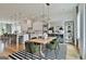 Open dining area connected to kitchen, featuring stylish decor, modern lighting, and ample seating at 145 Kelmscott Ln, Fayetteville, GA 30214