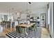 Open-concept kitchen and dining room features modern lighting, hardwood floors and seating for six at 145 Kelmscott Ln, Fayetteville, GA 30214