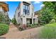 Stylish white brick home featuring a balcony and beautifully landscaped front yard at 145 Kelmscott Ln, Fayetteville, GA 30214
