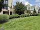 Serene front yard featuring meticulously maintained lawn and beautifully landscaped garden beds at 145 Kelmscott Ln, Fayetteville, GA 30214