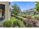 View of the community garden with green grass, flowers and gravel paths between the modern homes at 145 Kelmscott Ln, Fayetteville, GA 30214