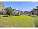 Expansive community green space surrounded by a variety of upscale modern homes and lush landscaping at 145 Kelmscott Ln, Fayetteville, GA 30214