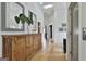 Light-filled hallway featuring hardwood floors, decorative mirrors, and access to other rooms at 145 Kelmscott Ln, Fayetteville, GA 30214
