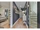 Inviting hallway with hardwood floors, elegant decor, and a staircase, leading to the bedroom at 145 Kelmscott Ln, Fayetteville, GA 30214