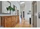Hallway with hardwood floors, wooden cabinet, decorative mirrors, and elevator access at 145 Kelmscott Ln, Fayetteville, GA 30214