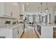 Modern, well-lit kitchen with stainless steel appliances, marble countertops, and sleek white cabinetry at 145 Kelmscott Ln, Fayetteville, GA 30214