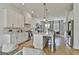 Modern kitchen features white cabinetry, marble countertops, stainless steel appliances and open layout at 145 Kelmscott Ln, Fayetteville, GA 30214