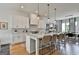 Bright, modern kitchen with white cabinets, marble countertops, and an island with seating at 145 Kelmscott Ln, Fayetteville, GA 30214