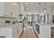 Modern kitchen with white cabinets, marble countertops, stainless appliances, and an open layout at 145 Kelmscott Ln, Fayetteville, GA 30214