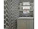 Laundry room with a front load washer and dryer and patterned wallpaper at 145 Kelmscott Ln, Fayetteville, GA 30214