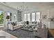 Bright living room featuring a white sofa, patterned rug, ample natural light, and stylish decor accents at 145 Kelmscott Ln, Fayetteville, GA 30214