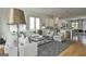 Bright and spacious living area with a modern design, white sofas, a glass coffee table, and hardwood floors at 145 Kelmscott Ln, Fayetteville, GA 30214