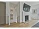 Bright living space with modern fireplace, hardwood floors, and elegant staircase at 145 Kelmscott Ln, Fayetteville, GA 30214