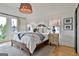 Bright main bedroom with king bed, large windows, and cozy decor for a relaxing retreat at 145 Kelmscott Ln, Fayetteville, GA 30214