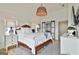 Main bedroom featuring a king bed, ample natural light, and elegant furnishings at 145 Kelmscott Ln, Fayetteville, GA 30214