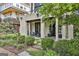 Outdoor patio space with chairs, table, potted plants, and a stone path leading through landscaped bushes at 145 Kelmscott Ln, Fayetteville, GA 30214