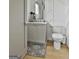 Stylish powder room with geometric accent wall, updated vanity, modern fixtures, and neutral color palette at 145 Kelmscott Ln, Fayetteville, GA 30214