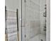 Luxurious walk-in shower featuring marble tile, a sleek glass door, and a modern shower head at 145 Kelmscott Ln, Fayetteville, GA 30214