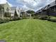 Scenic neighborhood street view showcasing homes with manicured lawns, lush gardens, and mature trees at 145 Kelmscott Ln, Fayetteville, GA 30214