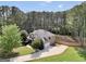 Spacious home with an attached garage, long driveway, and surrounded by lush greenery at 204 Carmell Ct, Mcdonough, GA 30252