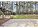 Secluded backyard with a gazebo, patio, and lush green lawn surrounded by trees at 204 Carmell Ct, Mcdonough, GA 30252