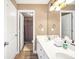 Bathroom with double sinks, white cabinets, and a separate shower area at 204 Carmell Ct, Mcdonough, GA 30252