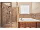 Bathroom featuring a glass shower, a soaking tub, and tile accents at 204 Carmell Ct, Mcdonough, GA 30252