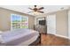 Cozy bedroom featuring a large window, ceiling fan, and wood dresser at 204 Carmell Ct, Mcdonough, GA 30252