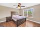 Bedroom with hardwood floors, a ceiling fan, and a large window at 204 Carmell Ct, Mcdonough, GA 30252