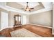 Large bedroom featuring a ceiling fan, hardwood floors and a large mirror at 204 Carmell Ct, Mcdonough, GA 30252