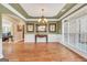 Spacious dining room with hardwood floors, wainscoting, and decorative lighting fixture at 204 Carmell Ct, Mcdonough, GA 30252