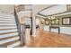 Grand entryway showcasing staircase with wrought iron railings, hardwood floors, and elegant chandelier at 204 Carmell Ct, Mcdonough, GA 30252