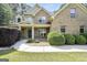 Well-maintained home featuring a mix of brick and siding, manicured shrubs, and covered porch at 204 Carmell Ct, Mcdonough, GA 30252