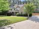 Lovely home with brick facade, mature trees, a well-manicured lawn, and inviting driveway at 204 Carmell Ct, Mcdonough, GA 30252