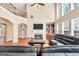 Bright living room with high ceilings, fireplace, and large windows at 204 Carmell Ct, Mcdonough, GA 30252