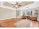 Spacious living room with hardwood floors, tray ceiling, and large windows at 204 Carmell Ct, Mcdonough, GA 30252
