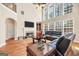 Open living room boasting a fireplace, custom built-ins, and large windows providing ample natural light at 204 Carmell Ct, Mcdonough, GA 30252