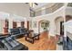 Open-concept living room featuring hardwood floors, fireplace, and second story at 204 Carmell Ct, Mcdonough, GA 30252