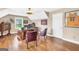 Home office showcasing a large wooden desk, hardwood floors, and natural lighting at 204 Carmell Ct, Mcdonough, GA 30252