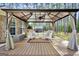 Inviting covered outdoor seating area with stylish furniture and a peaceful view of the wooded backyard at 204 Carmell Ct, Mcdonough, GA 30252