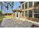 Brick home featuring a spacious stone patio and a well-manicured lawn at 204 Carmell Ct, Mcdonough, GA 30252