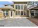 Brick house featuring a stone patio and manicured lawn with outdoor seating at 204 Carmell Ct, Mcdonough, GA 30252
