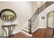Beautiful staircase featuring wood treads, white risers, and decorative wrought iron spindles at 204 Carmell Ct, Mcdonough, GA 30252