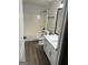 Full bathroom featuring a shower/tub combo, new vanity, and hardwood floors at 140 Clover Valley Dr, Covington, GA 30016