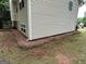 Exterior shot of the side of a house with green grass and pine straw at 140 Clover Valley Dr, Covington, GA 30016